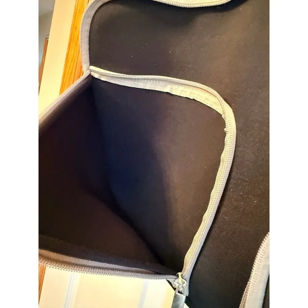 Black laptop sleeve bag features gray zipper compartment carrying handle.